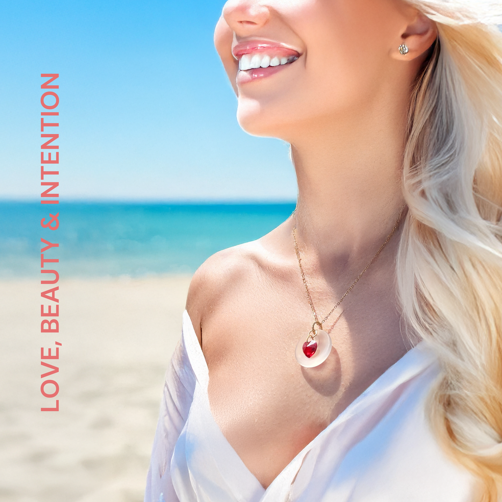 Cultured sea glass (crafted from natural sand), red crystal heart, 18" stainless steel gold-tone chain SIZE: 1" moon charm pendant, 18" inch necklace. ORIGIN: Handcrafted in Florida, USA